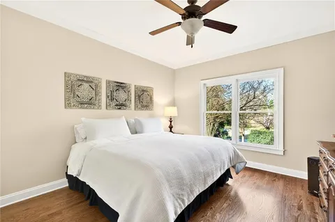 a bedroom with a large bed and a window