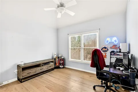 a view of a workspace with furniture and a window