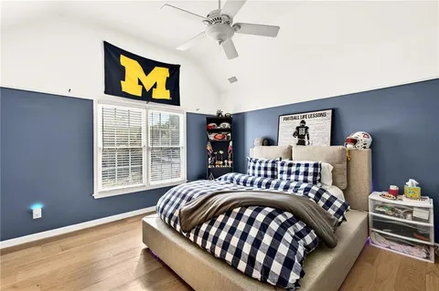 a bedroom with a bed and wooden floor