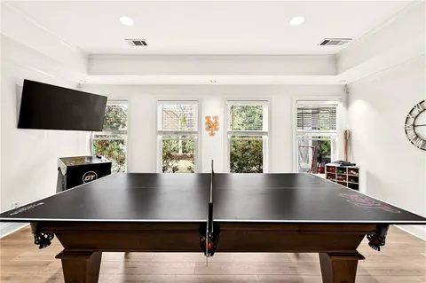 a living room with a table and flat screen tv