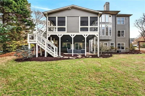 a front view of a house with swimming pool and porch