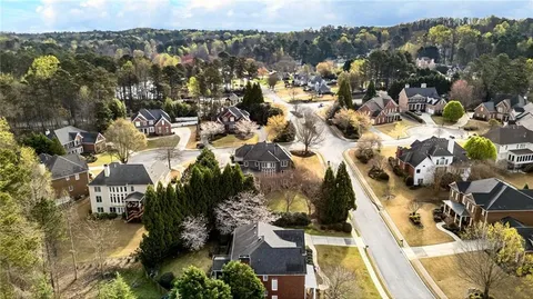 an aerial view of a house with a yard