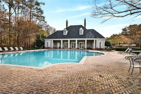 a swimming pool with outdoor seating and yard