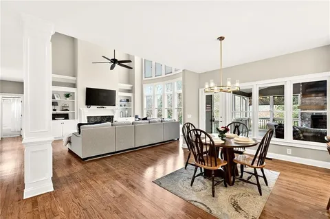a view of a dining room with furniture window and wooden floor