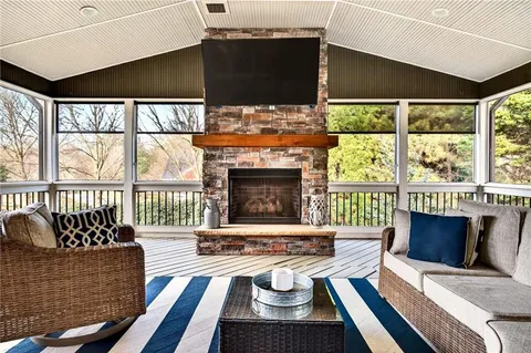 a living room with furniture fireplace and a floor to ceiling window