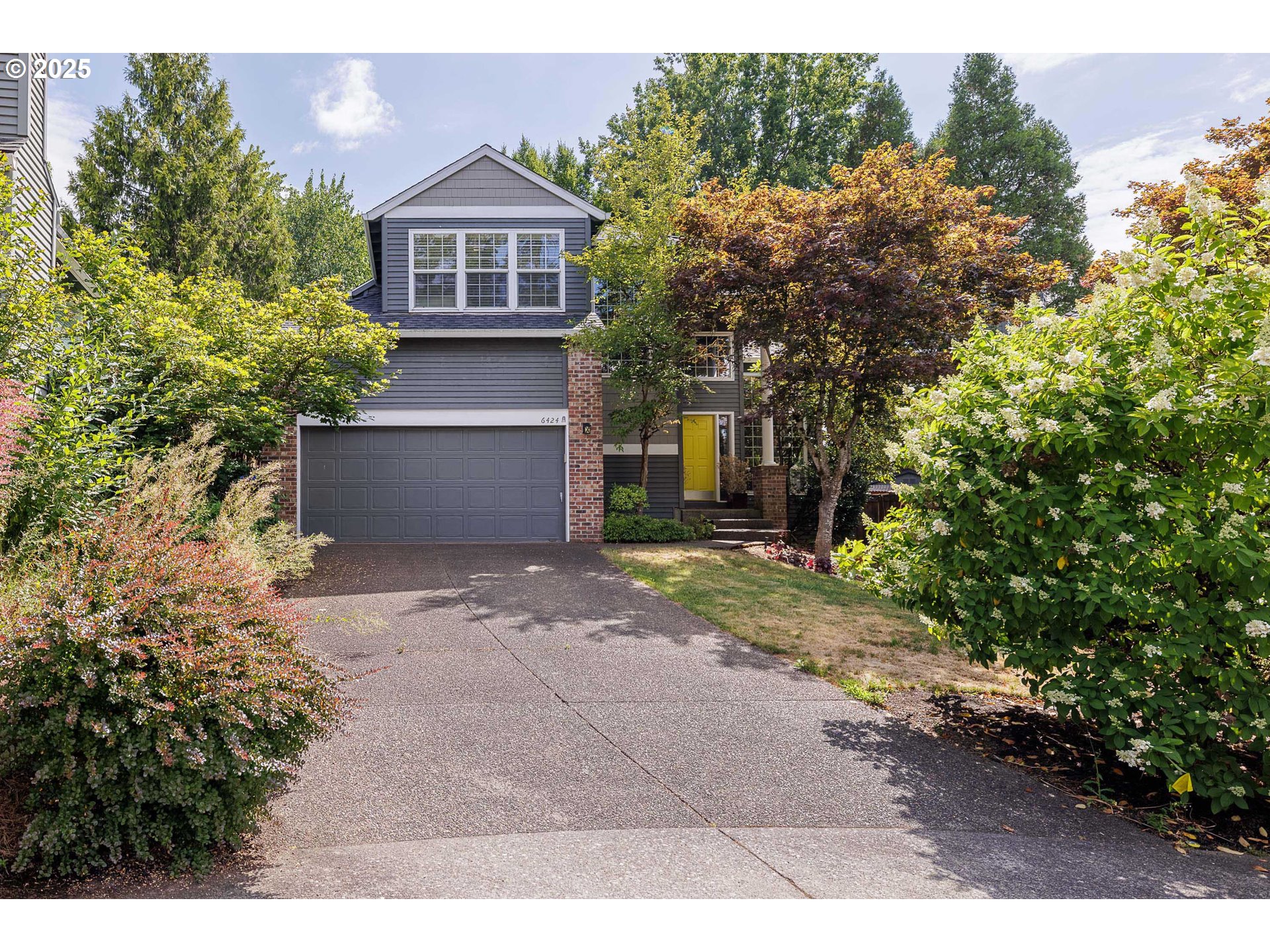 6424 Southwest Flower Street Portland, OR 97221 - Photo 1 of 29 a front view of a house with a yard and a garage