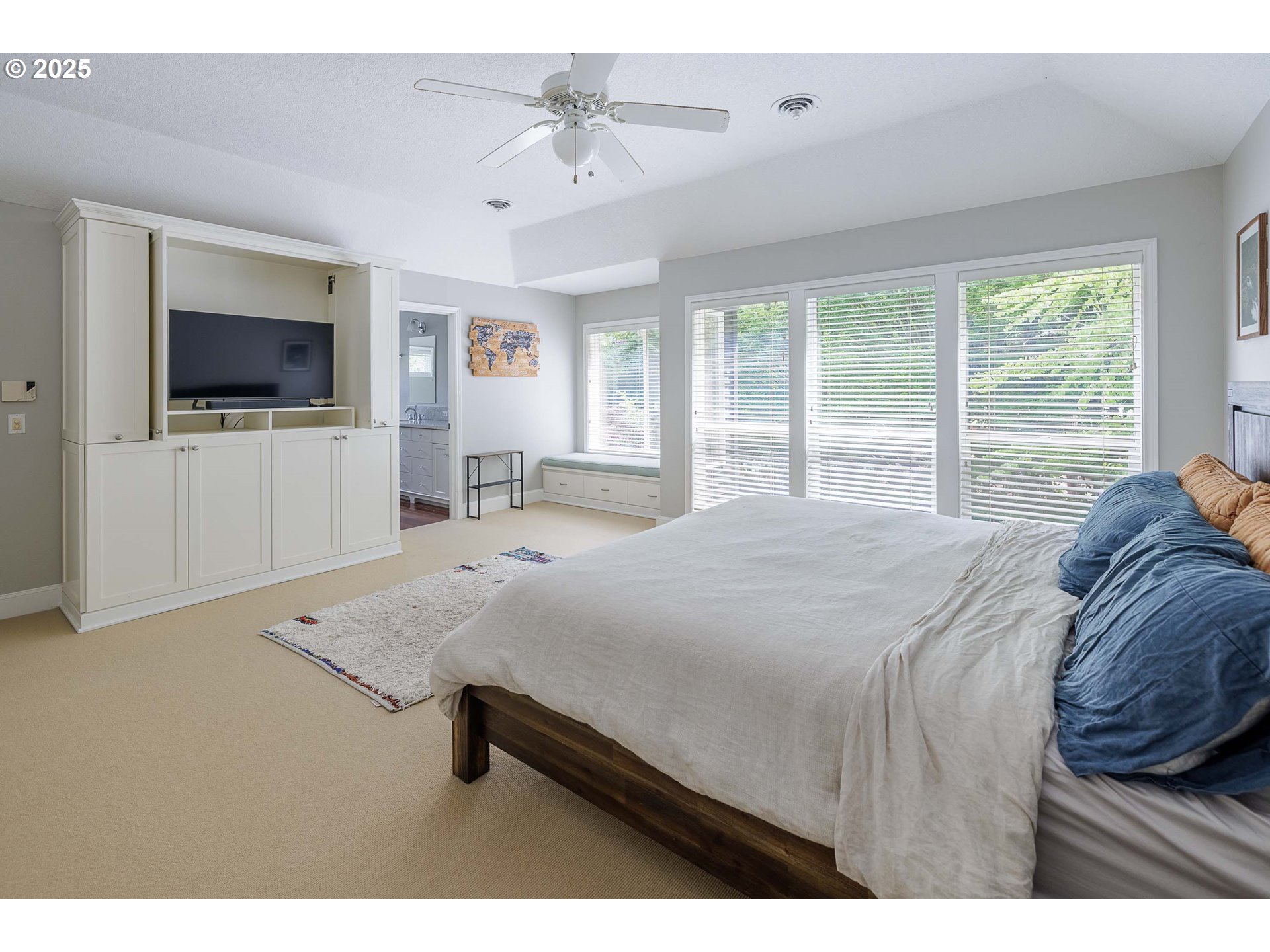 6424 Southwest Flower Street Portland, OR 97221 - Photo 12 of 29 a bedroom with a large bed and a flat screen tv