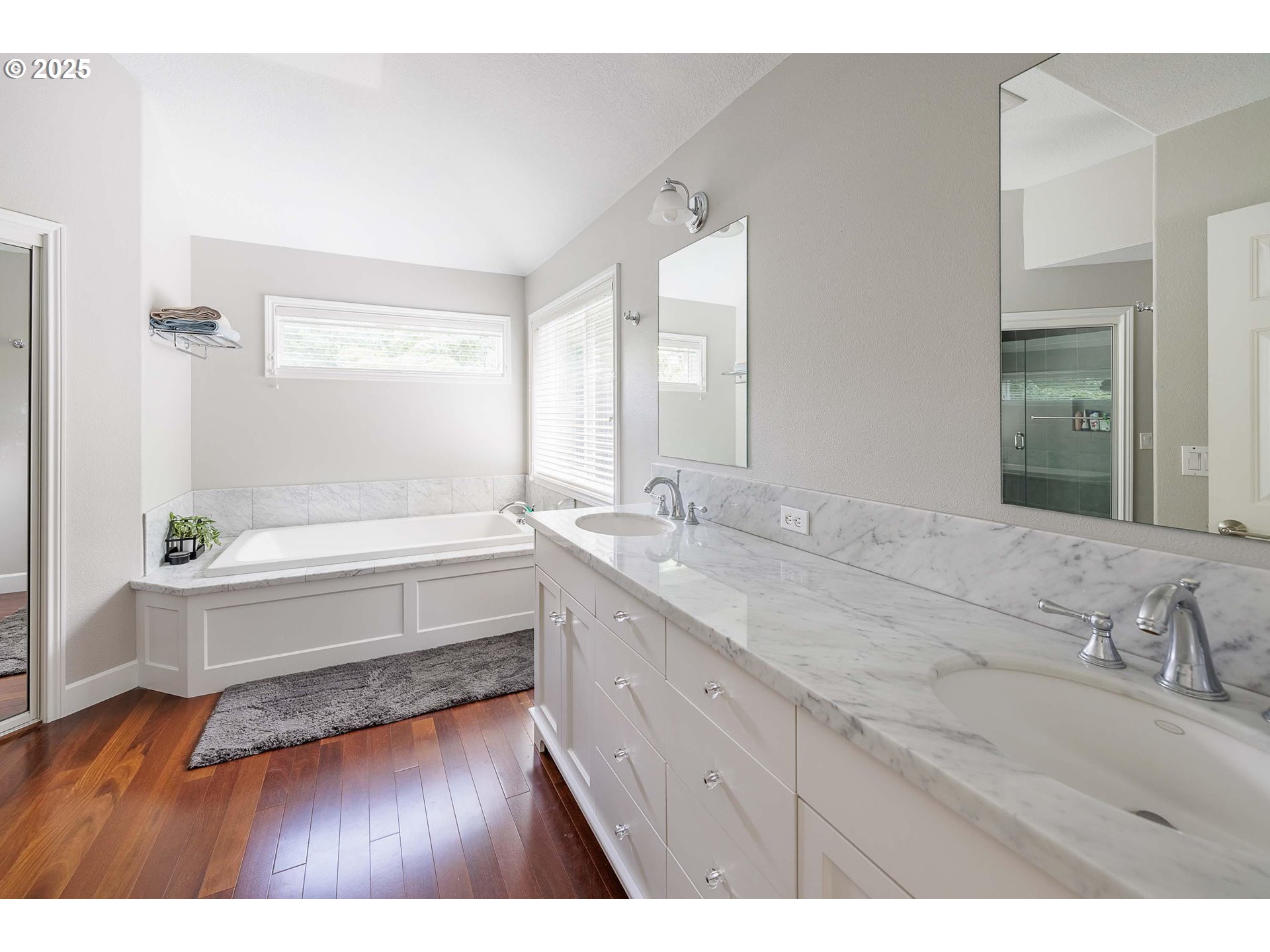 6424 Southwest Flower Street Portland, OR 97221 - Photo 13 of 29 a bathroom with a tub sink and mirror