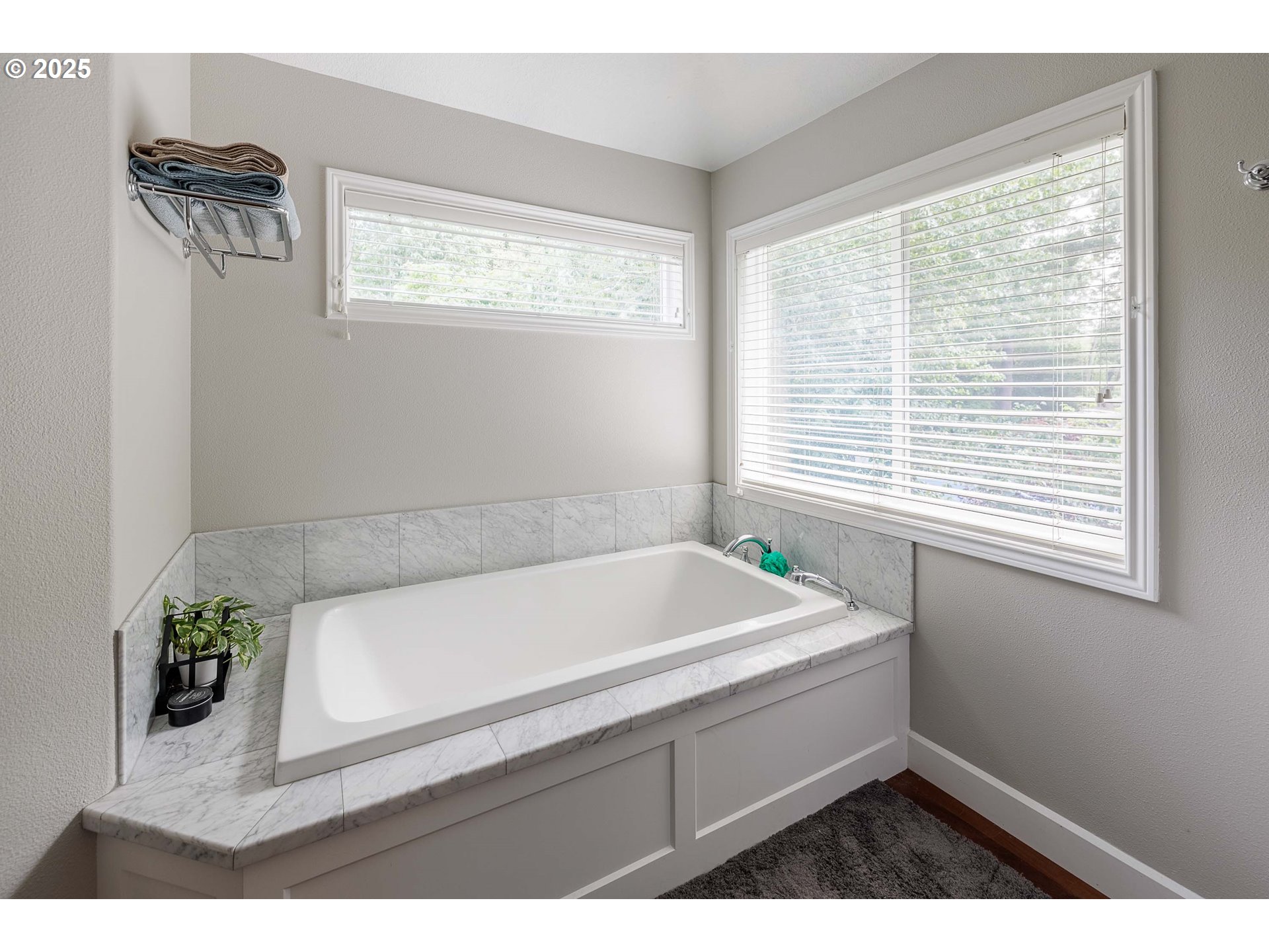 6424 Southwest Flower Street Portland, OR 97221 - Photo 14 of 29 a bathroom with a bathtub and a window