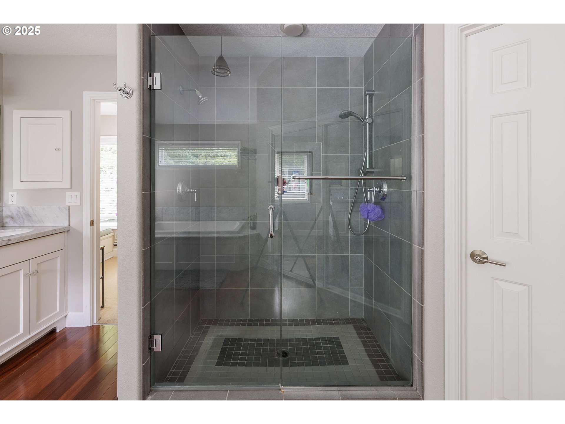 6424 Southwest Flower Street Portland, OR 97221 - Photo 17 of 29 a bathroom with a glass shower door
