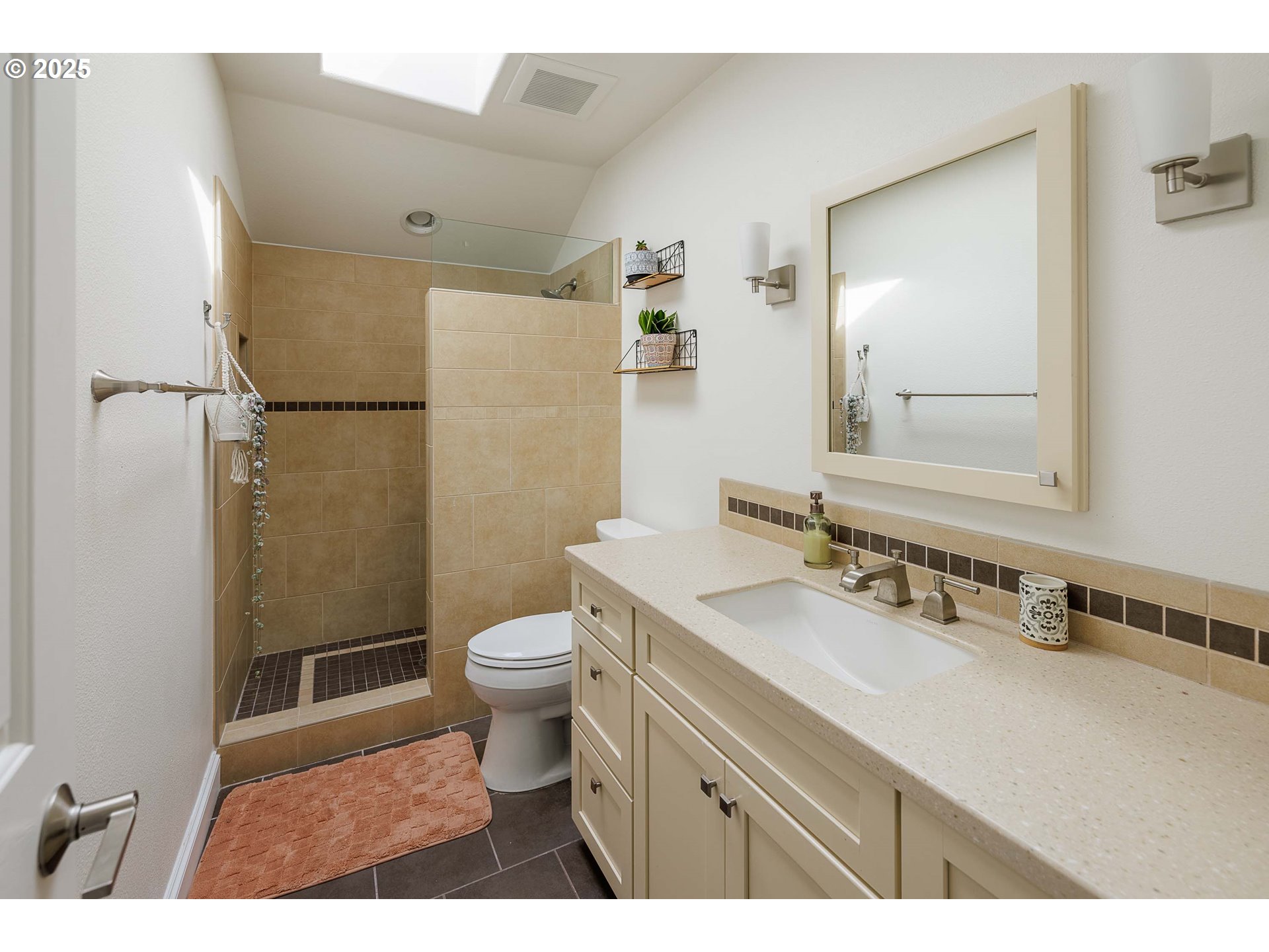 6424 Southwest Flower Street Portland, OR 97221 - Photo 19 of 29 a bathroom with a sink a toilet a mirror and shower