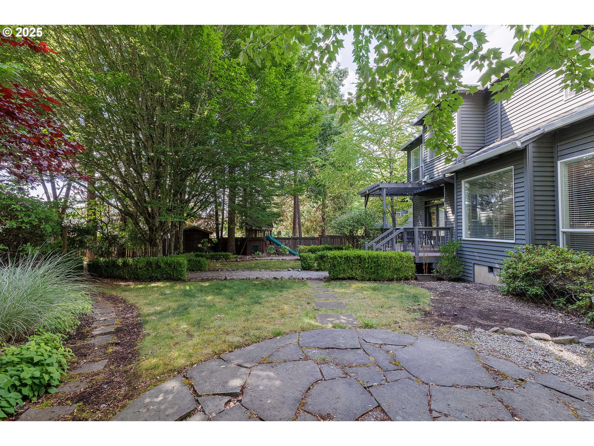 6424 Southwest Flower Street Portland, OR 97221 - Photo 27 of 29 a view of a yard with plants and large trees