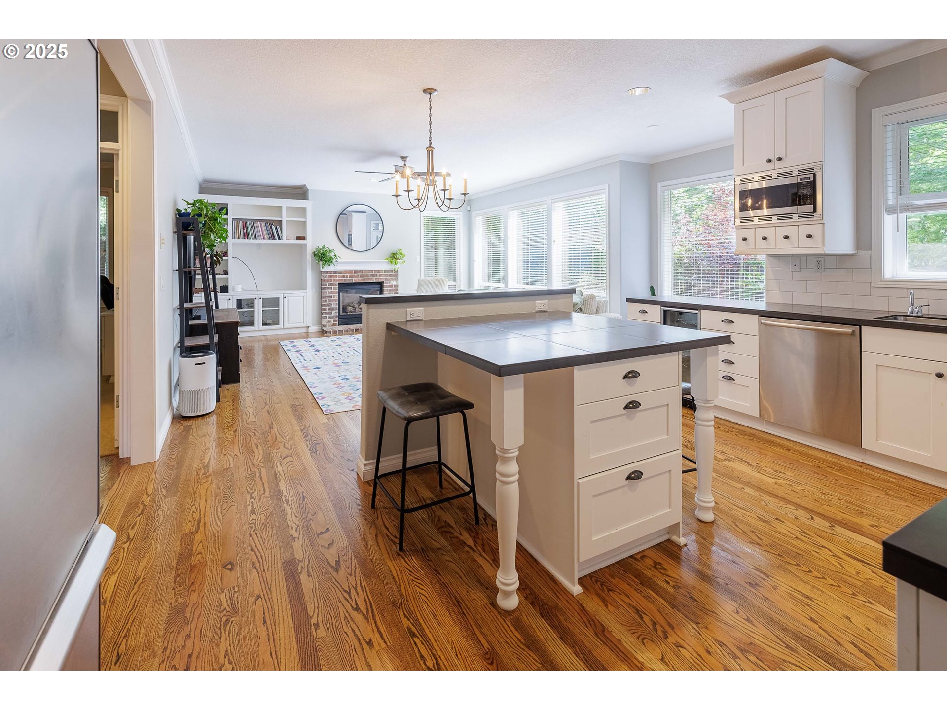 6424 Southwest Flower Street Portland, OR 97221 - Photo 4 of 29 a kitchen with granite countertop a sink cabinets and wooden floor