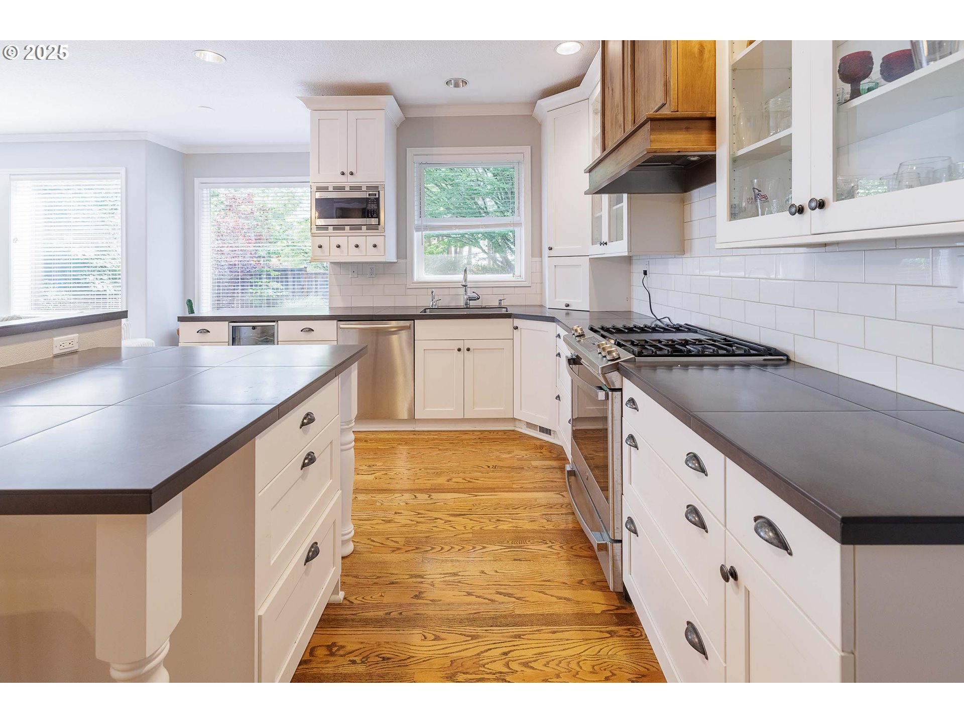 6424 Southwest Flower Street Portland, OR 97221 - Photo 5 of 29 a kitchen with granite countertop a stove a sink and a refrigerator