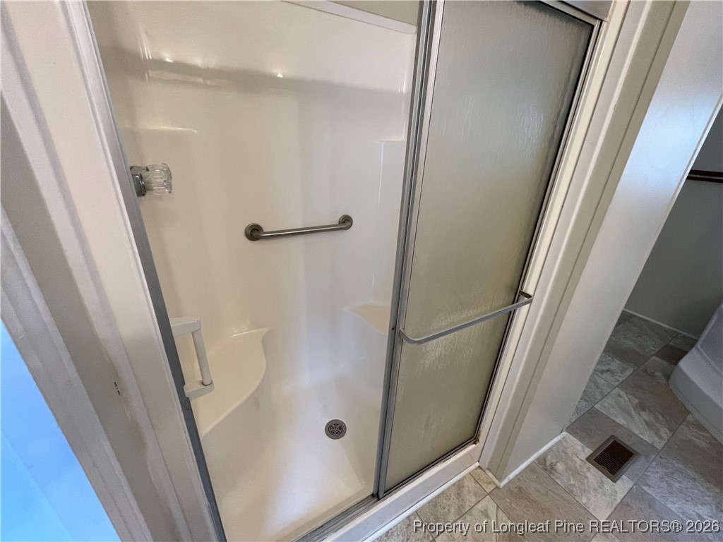 5922 Shiloah Church Road Fayetteville, NC 28306 - Photo 19 of 23 a bathroom with a glass door shower and toilet