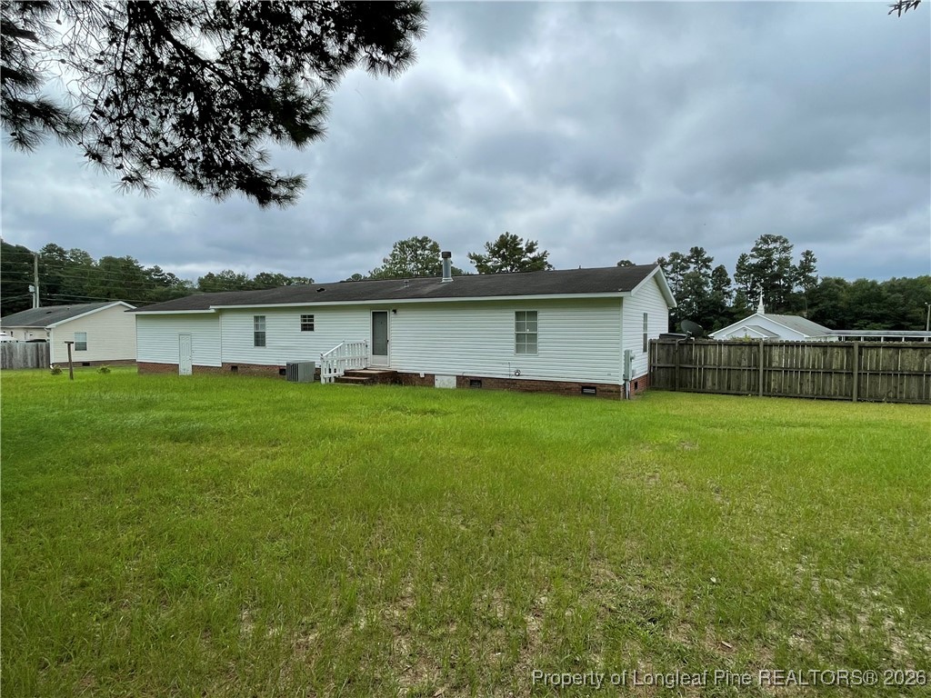 5922 Shiloah Church Road Fayetteville, NC 28306 - Photo 22 of 23 a view of a house next to a lake with a big yard