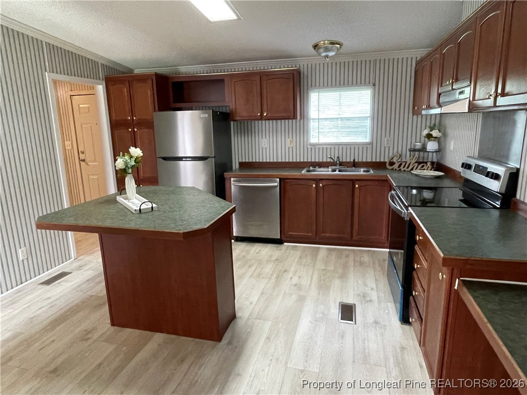 5922 Shiloah Church Road Fayetteville, NC 28306 - Photo 7 of 23 a kitchen with kitchen island granite countertop a sink stove and refrigerator
