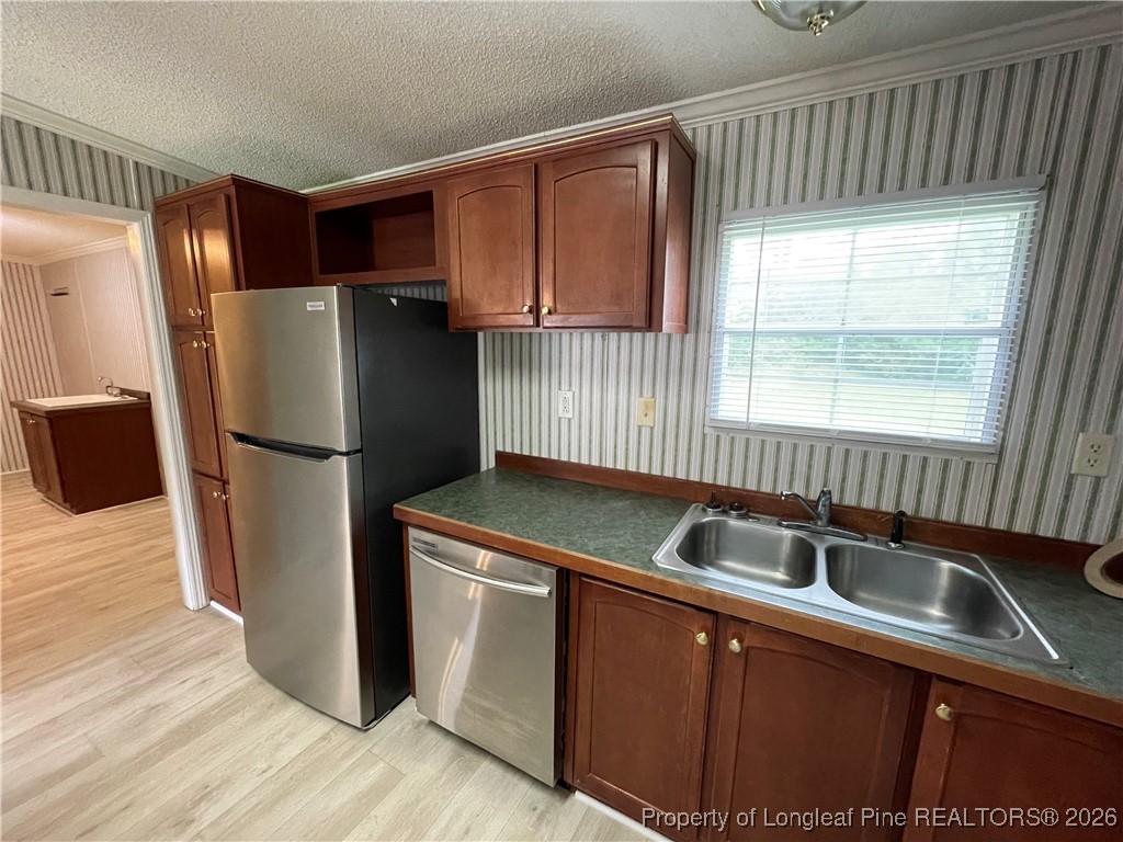 5922 Shiloah Church Road Fayetteville, NC 28306 - Photo 9 of 23 a kitchen with stainless steel appliances granite countertop a refrigerator a sink and a granite counter tops with wooden floors