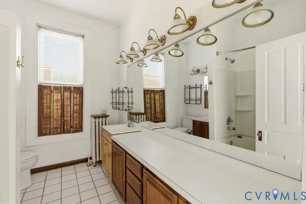 a view of backyard with large trees and wooden fence