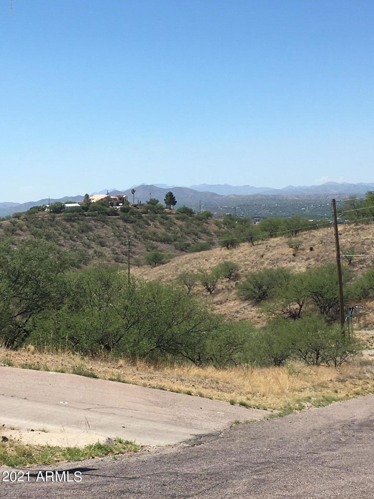 427 Tonichi Court, Unit 76 Rio Rico, AZ 85648 - Photo 1 of 5 a view of a dry yard with wooden fence