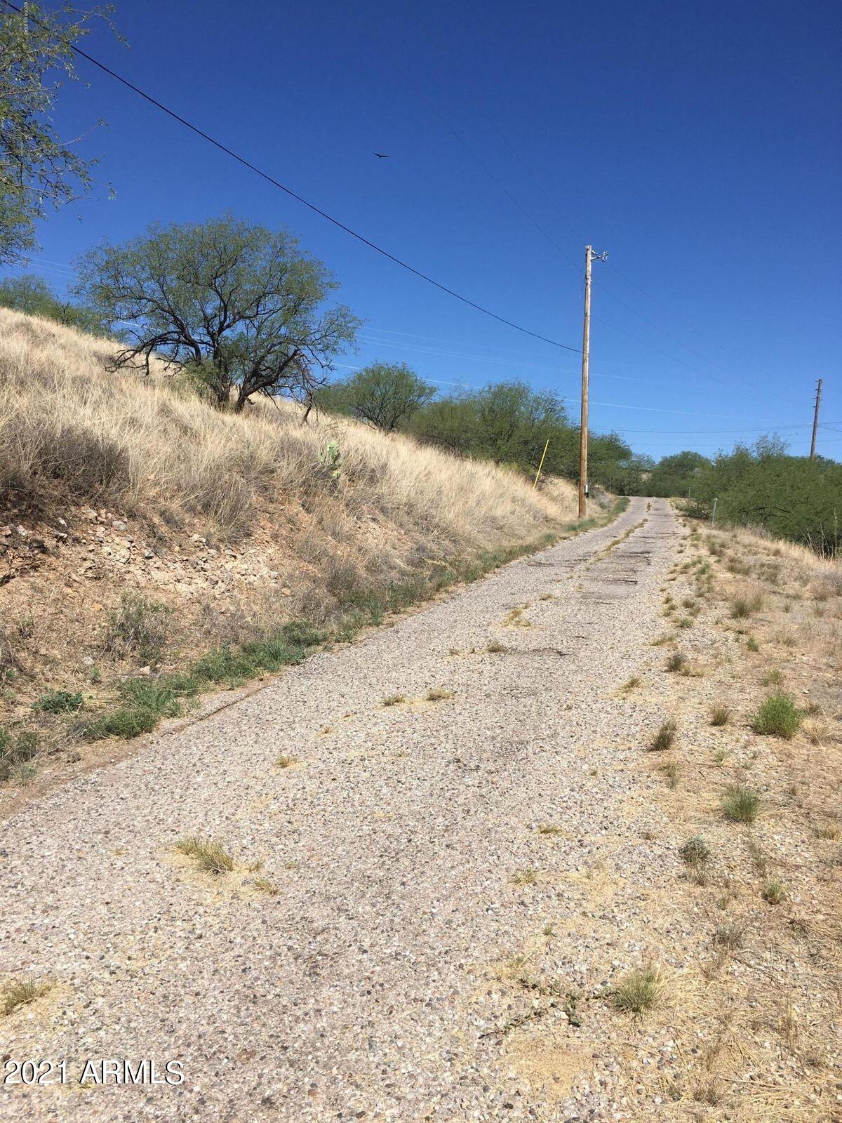 427 Tonichi Court, Unit 76 Rio Rico, AZ 85648 - Photo 5 of 5 a view of a dry yard with a tree