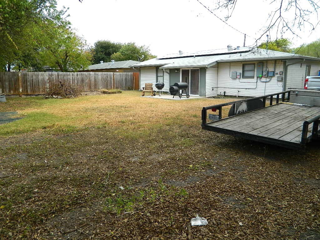101 Maple Drive Portland, TX 78374 - Photo 11 of 11 a view of a patio with table and chairs potted plants and wooden fence