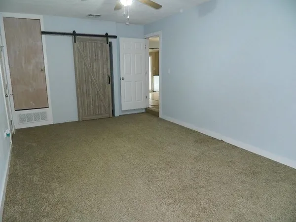 an empty room with closet area
