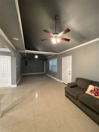 a living room with furniture and a chandelier