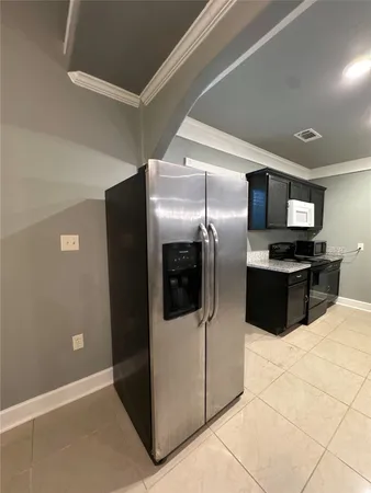 a kitchen with stainless steel appliances a refrigerator a microwave a sink and a stove