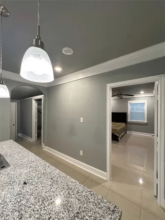 a view of a hallway and a livingroom with a chandelier