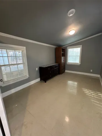 an empty room with windows and pillars in it