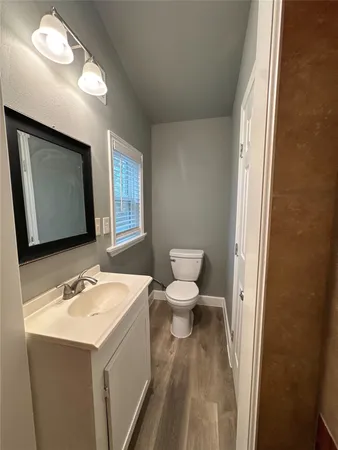 a bathroom with a sink toilet and mirror
