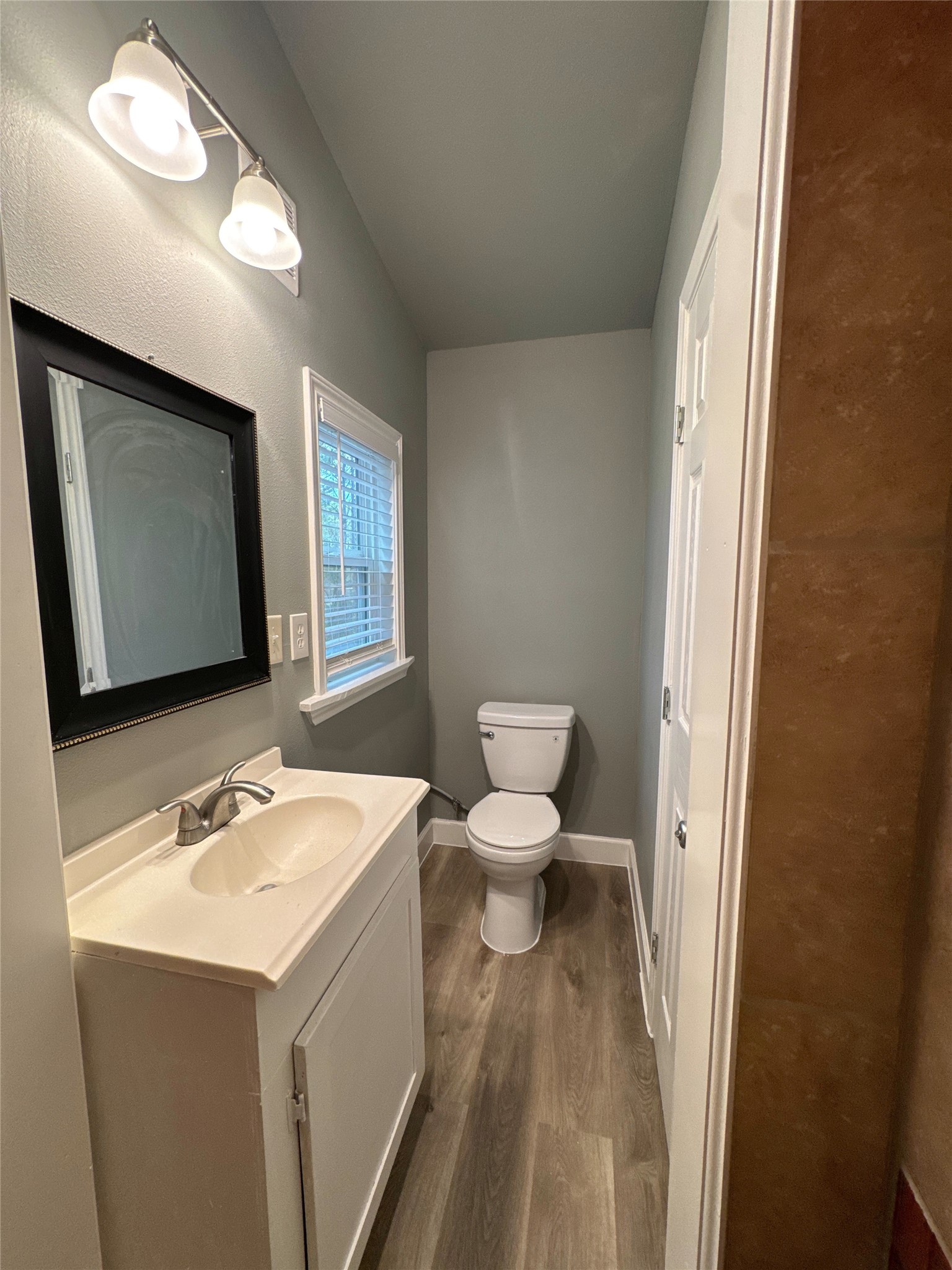 58 County Road 3560 Cleveland, TX 77327 - Photo 9 of 32 a bathroom with a sink toilet and mirror
