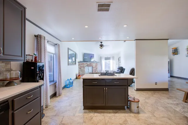 a kitchen with stainless steel appliances granite countertop a refrigerator stove and sink
