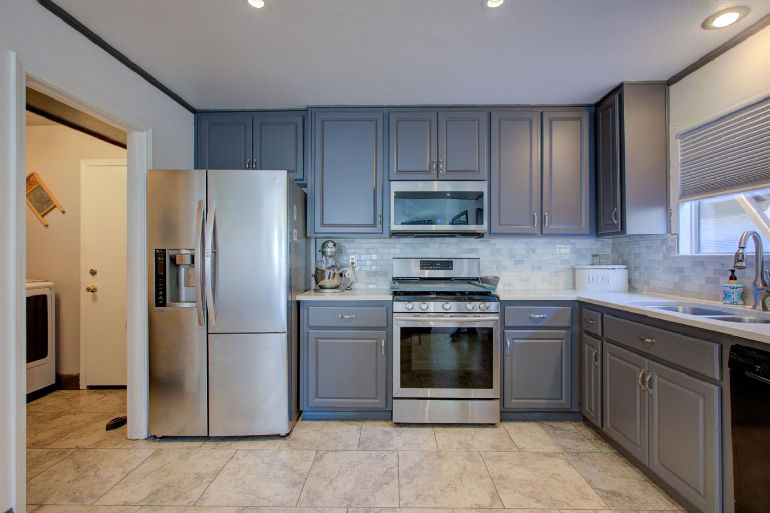 604 Kinshire Way Patterson, CA 95363 - Photo 15 of 42 a kitchen with stainless steel appliances granite countertop a refrigerator stove and sink