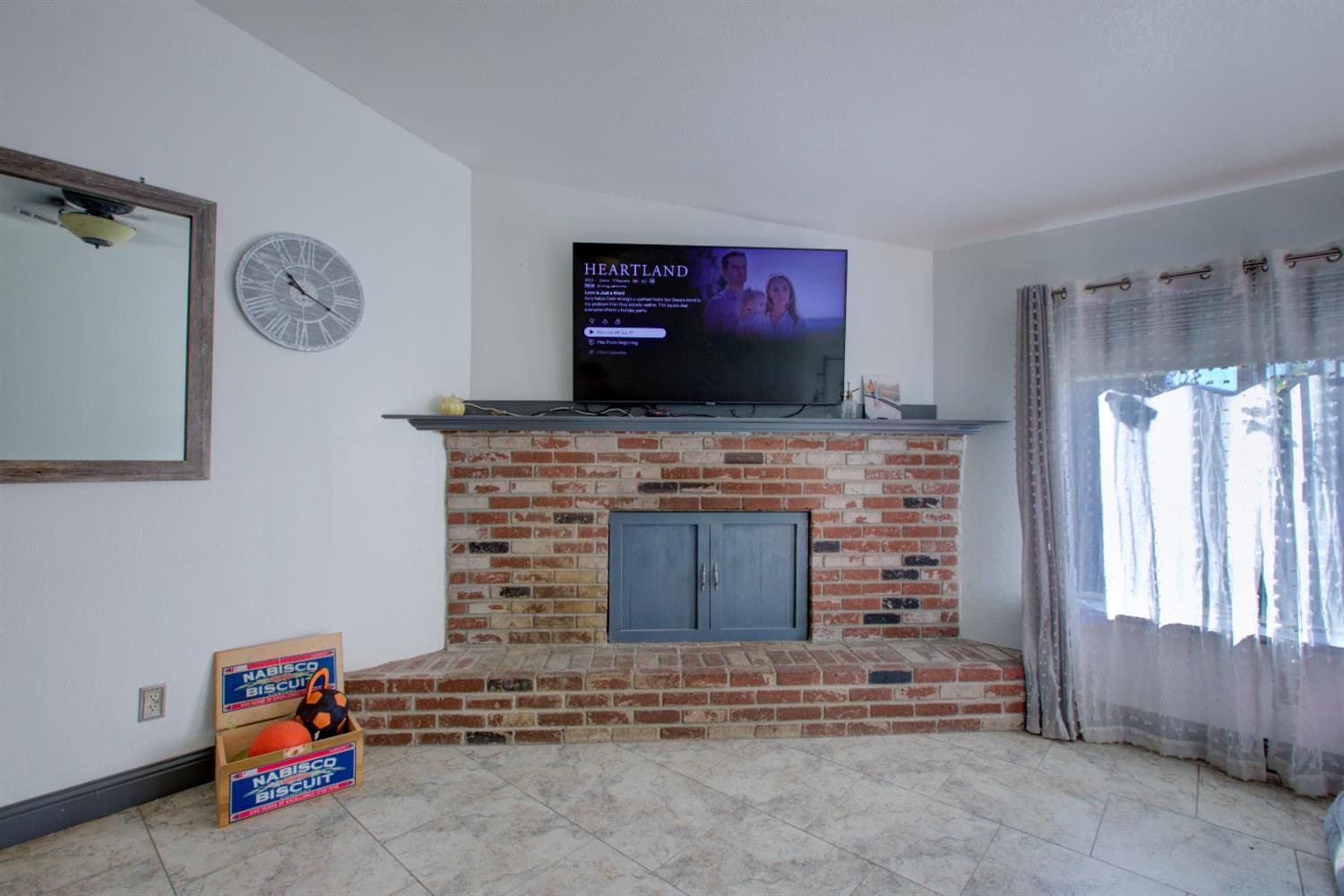 604 Kinshire Way Patterson, CA 95363 - Photo 18 of 42 a living room with fireplace furniture and a flat screen tv