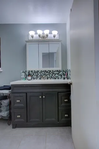 a view of room with a ceiling fan and wooden floor