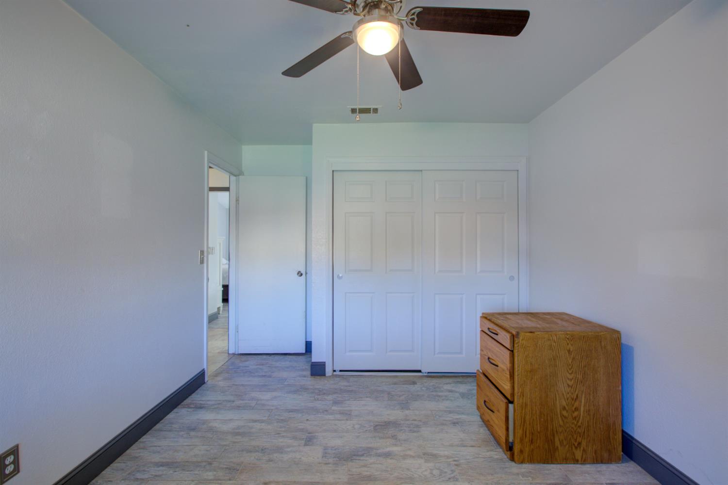 604 Kinshire Way Patterson, CA 95363 - Photo 22 of 42 a view of room with a ceiling fan and wooden floor