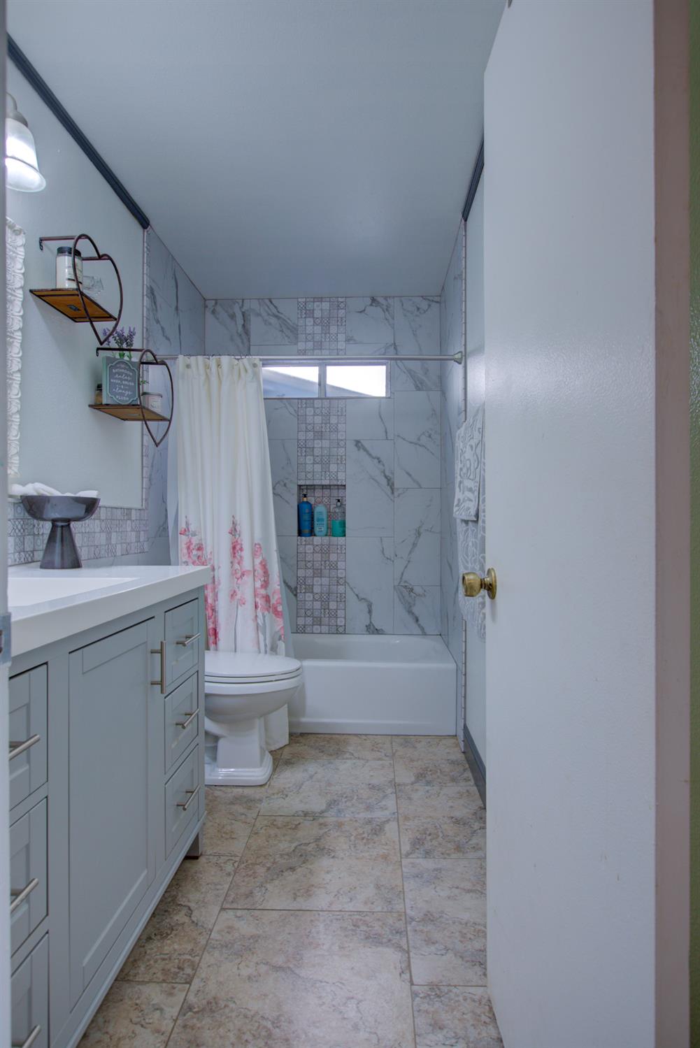 604 Kinshire Way Patterson, CA 95363 - Photo 30 of 42 a bathroom with a double vanity sink a toilet and shower