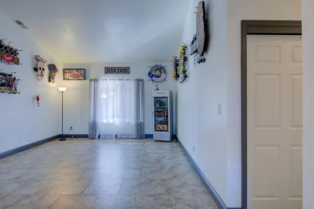 a view of a livingroom with an empty space and hallway