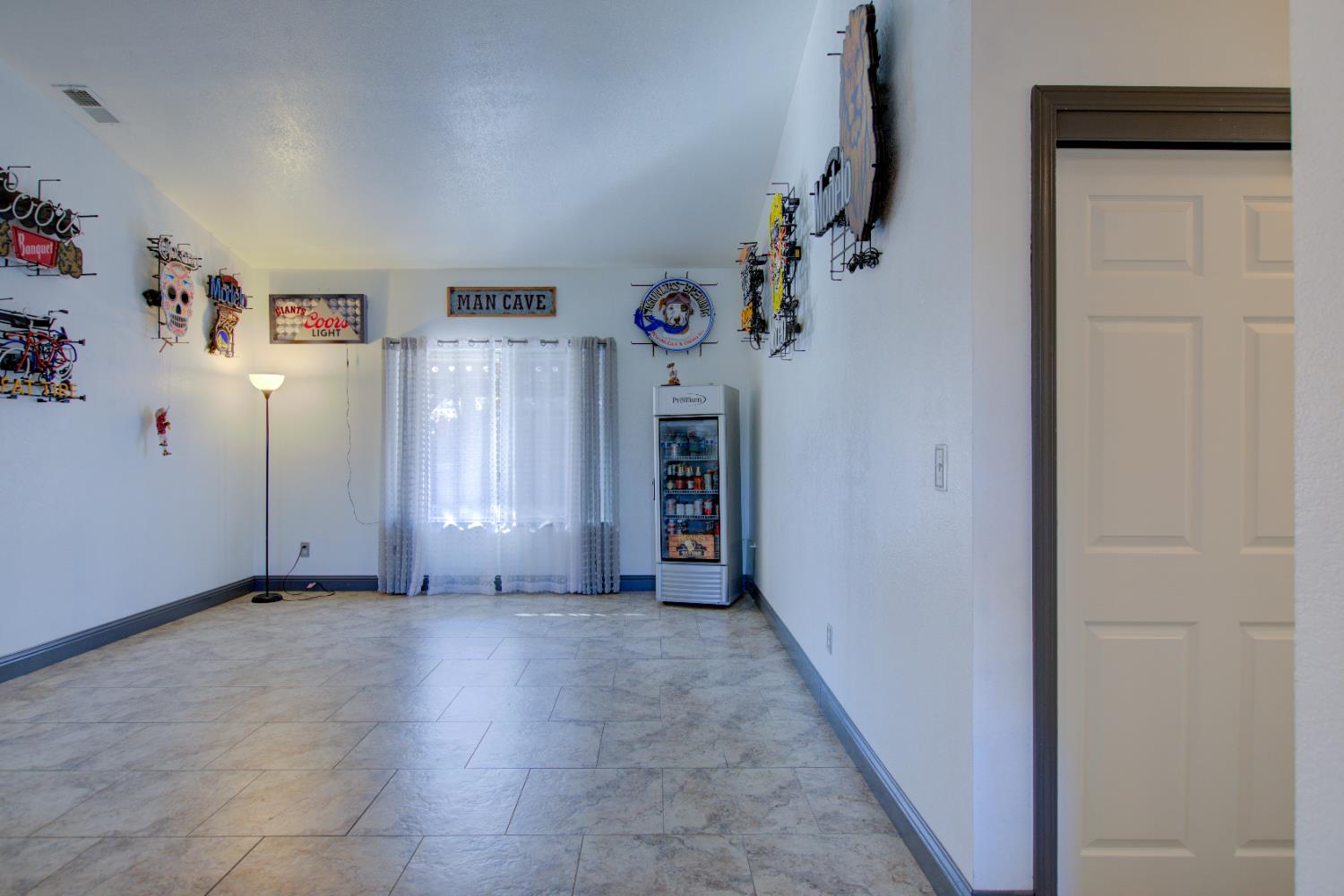 604 Kinshire Way Patterson, CA 95363 - Photo 6 of 42 a view of a livingroom with an empty space and hallway
