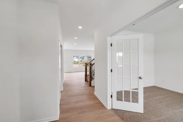 a view of a hallway with wooden shelves