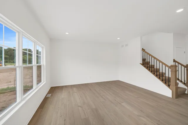 a view of a room with wooden floor and windows