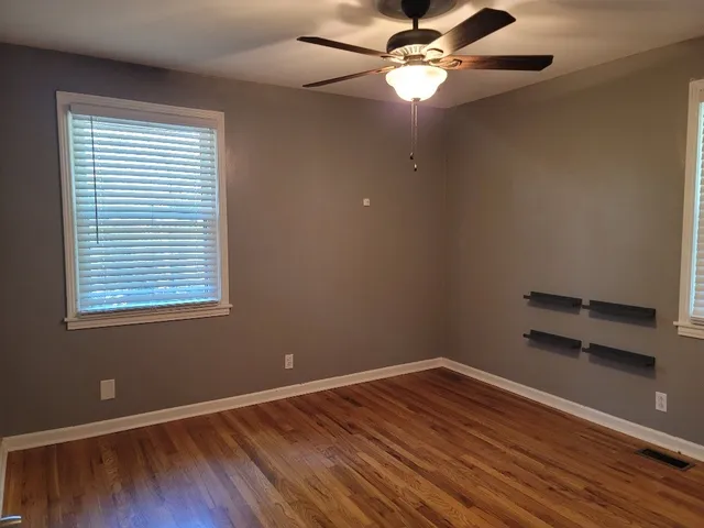 wooden floor in an empty room with a window