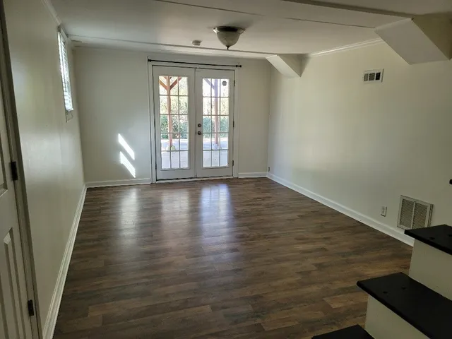 a view of an entryway with wooden floor
