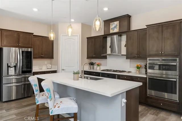 a kitchen with a sink a microwave and cabinets