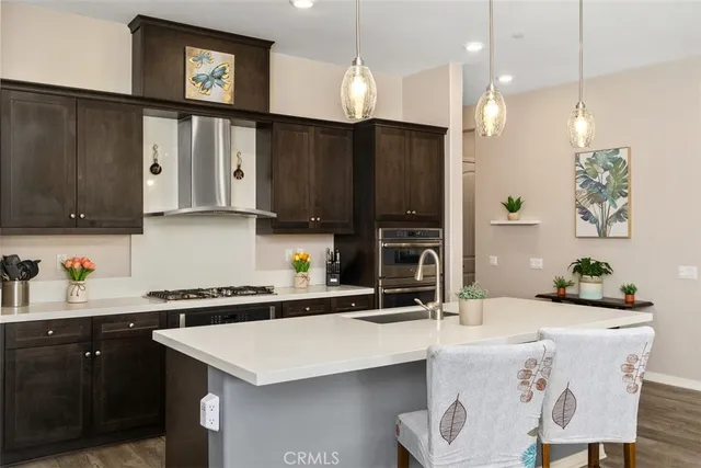 a kitchen with stainless steel appliances a stove a refrigerator and cabinets