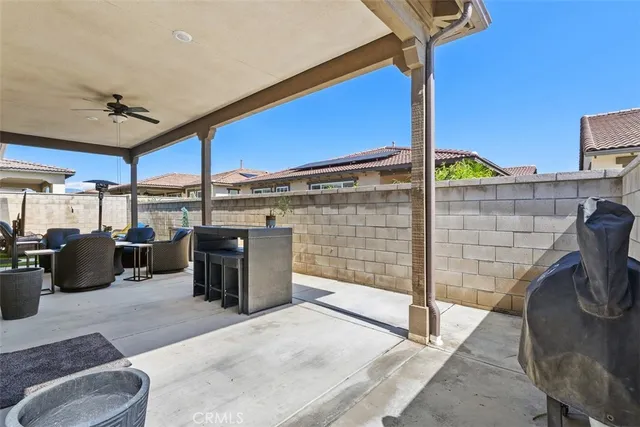 a view of a patio with couches table and chairs and potted plants