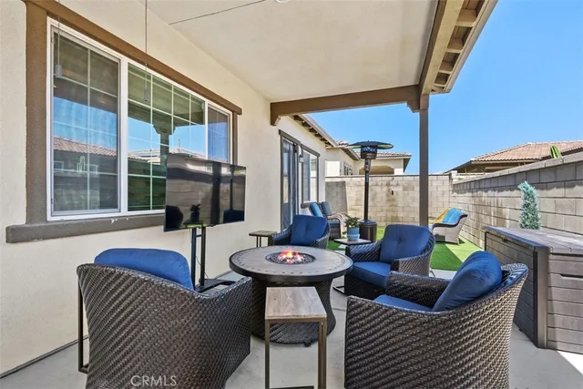 a backyard of a house with outdoor seating