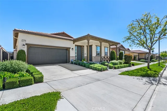 a front view of a house with a garden